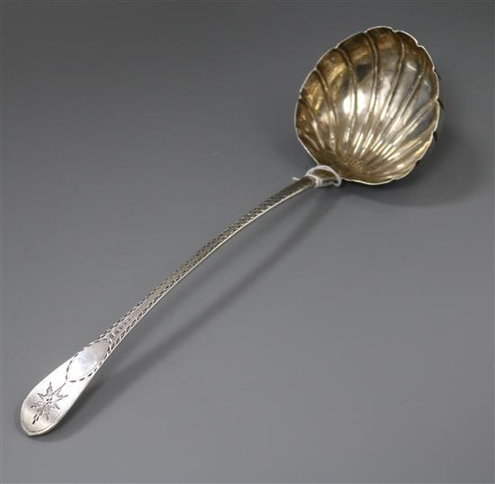 A George IV bright cut engraved silver celtic tip soup ladle with shell bowl, William Chawner II, London, 1821, a.f.